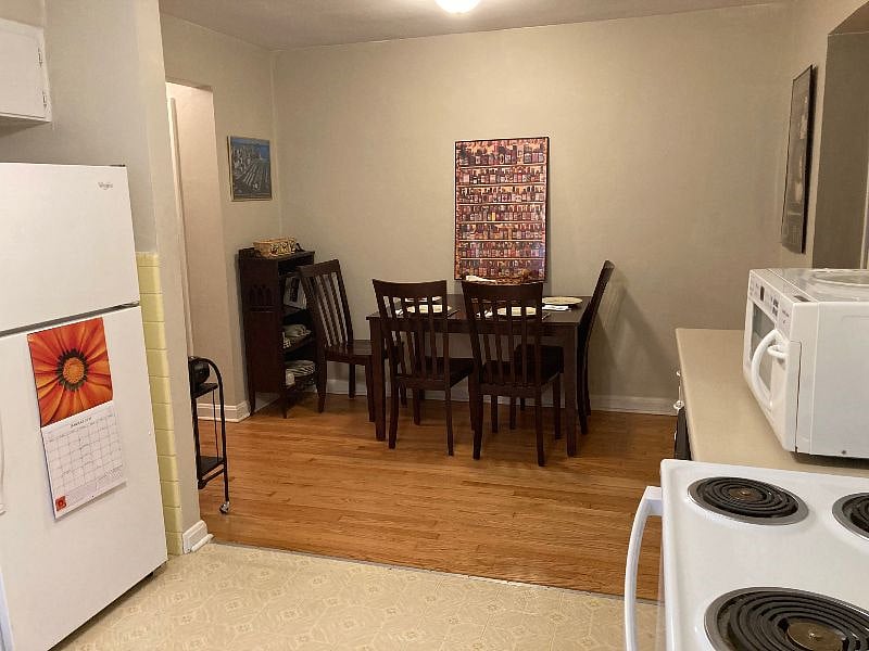 Spacious dining area adjacent to completely stocked kitchen: full size refrigerator, stove, and dishwasher 