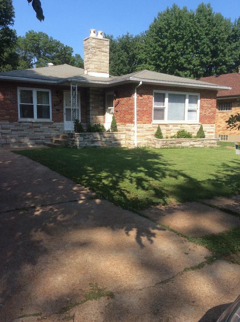 Brick Duplex faces tree-lined avenue with magnificent oak trees