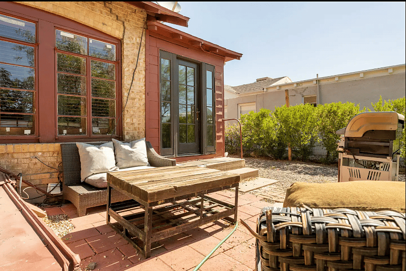 private, shaded backyard seating area and bbq