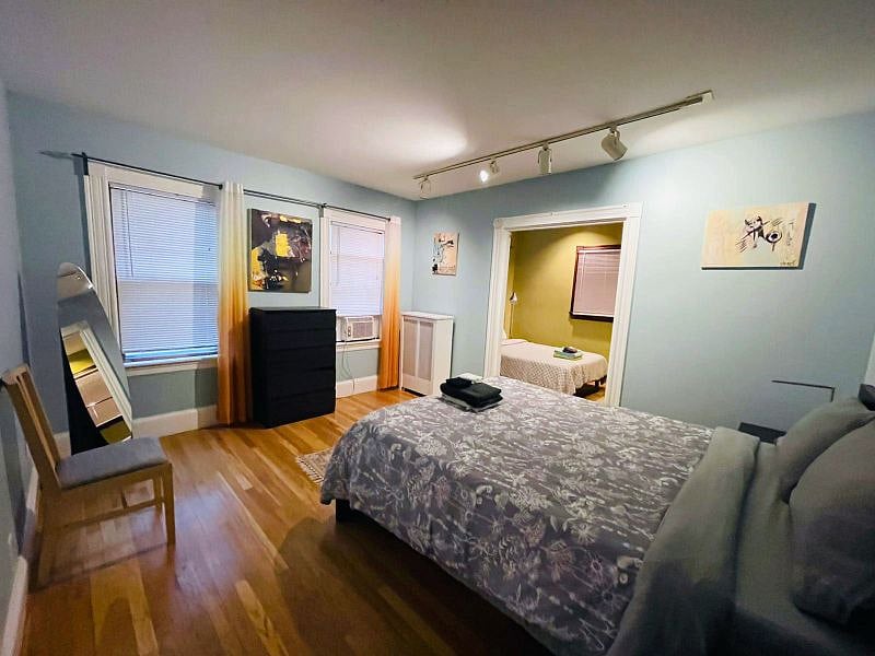 Master bedroom connected with a small bedroom by a sliding door