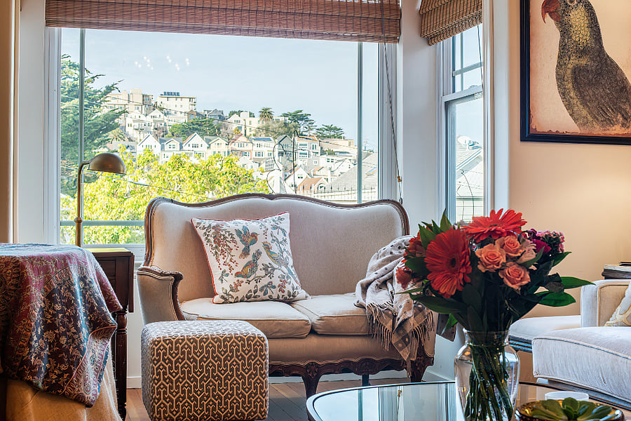 Enjoy the bay window and view from this seating area in the living room. Looks towards the jewel box like dining room.