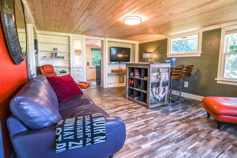 Spacious living room area with large, flat screen, adjustable TV