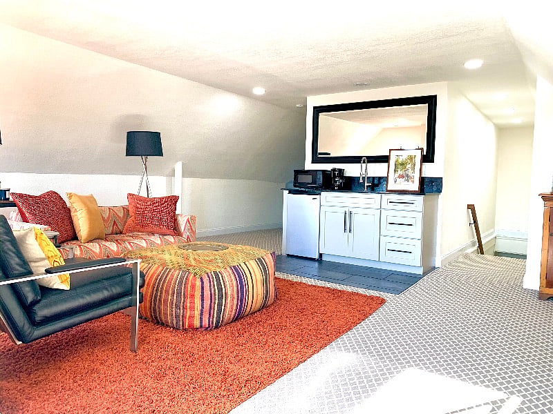 A handy kitchenette with coffee maker, mini fridge, dishes, utensils, and glass ware. 