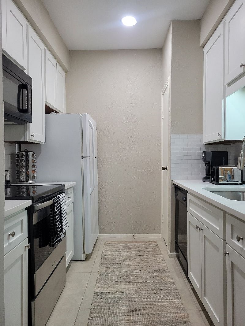 Fully stocked kitchen with a refrigerator, pantry, new oven and microwave.