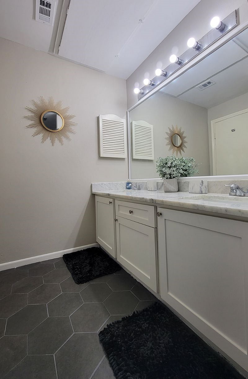 Primary bathroom with updated double sink vanity and quartz counter top.