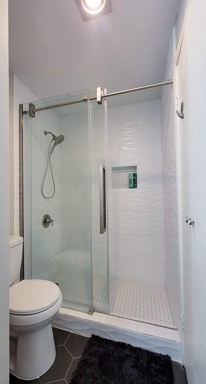 Newly updated luxurious walk in shower with glass sliding door!