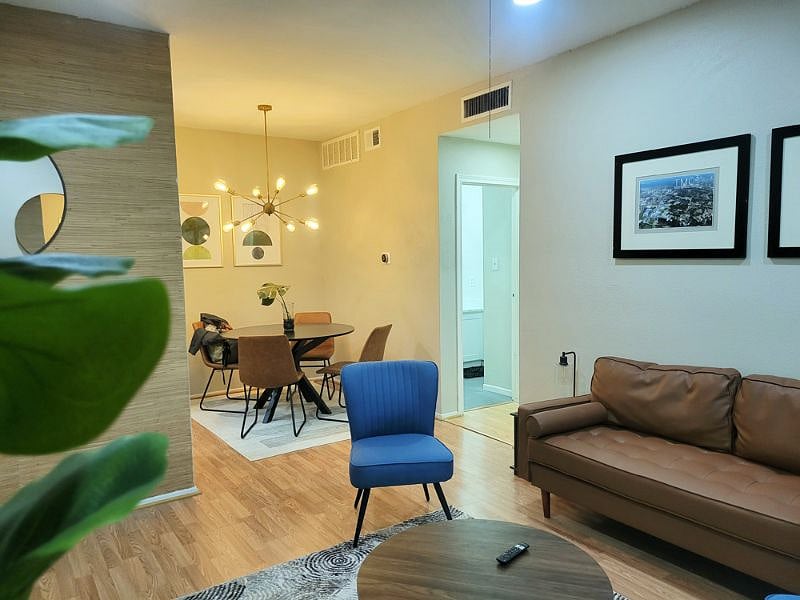 Living room, entrance way, eating area, and hallway to bedroom and bathroom.
