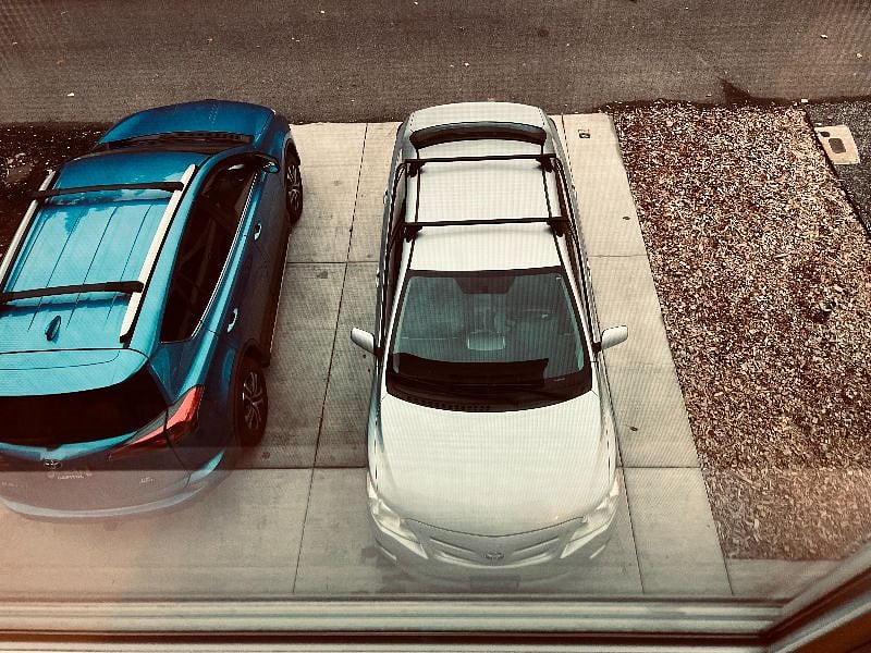Your parking spot is the gray car, next to the stairs.