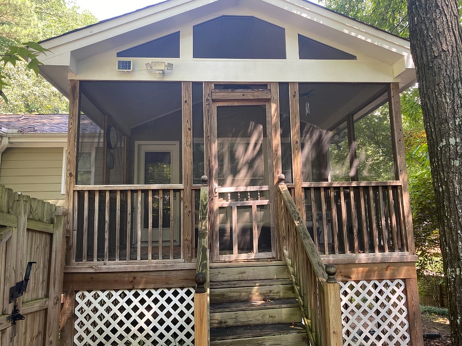 A few steps lead to the screened porch entrance. Motion-activated lights provide ample light at night.