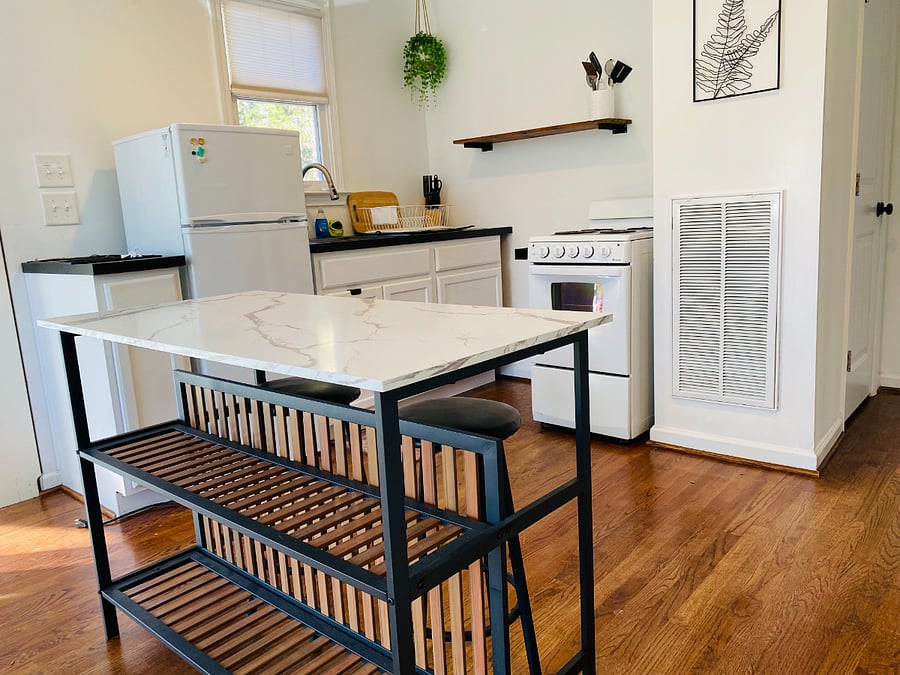 Kitchen island/bar so you can sit and enjoy some quiet time before starting your day. Doubles as extra work space for those who like to cook.