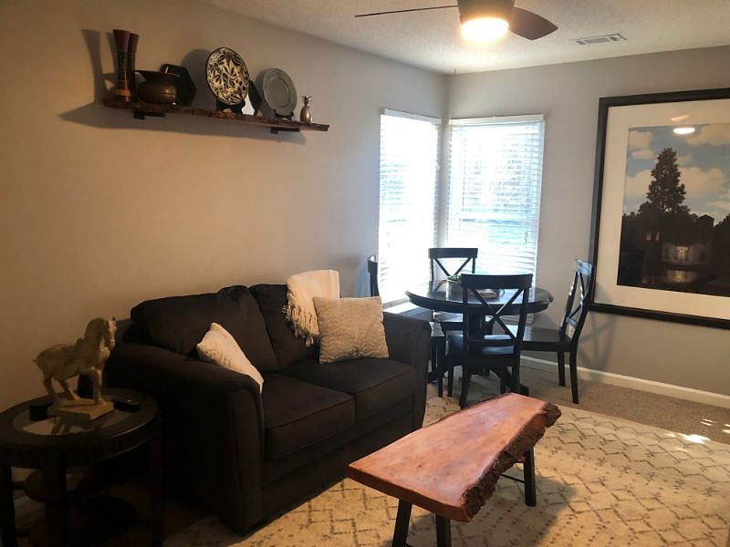 Lounge room, couch, TV, dining table, bar cart