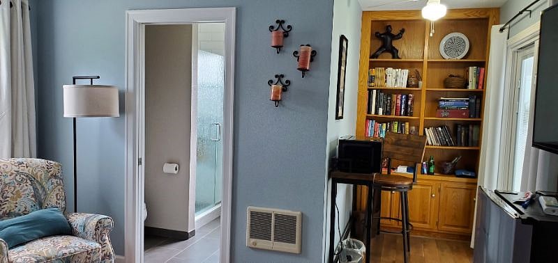 Coffee bar and lending library, laptop central. Recliner and TV.