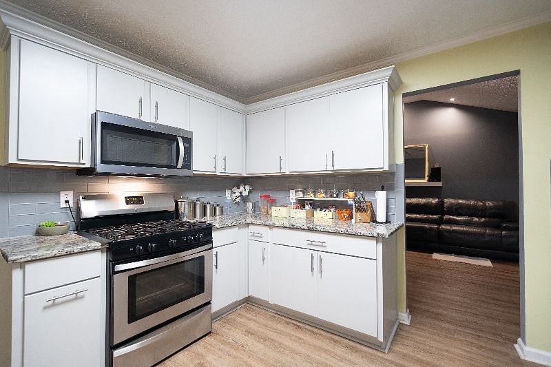 The kitchen brings you into the movie room / den.