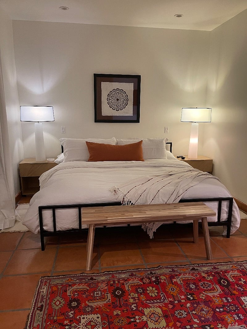 Extra large, light, and bright luxurious master suite with king-size bed, black drapes, make-up vanity, walk-in closet, and en-suite, master bath.