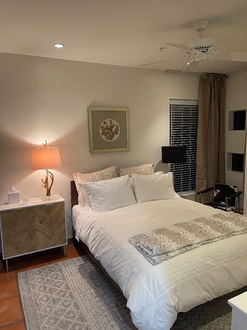 2nd bedroom with queen bed, inclusive of blackout drapes with sliding glass doors, walking onto private patio.