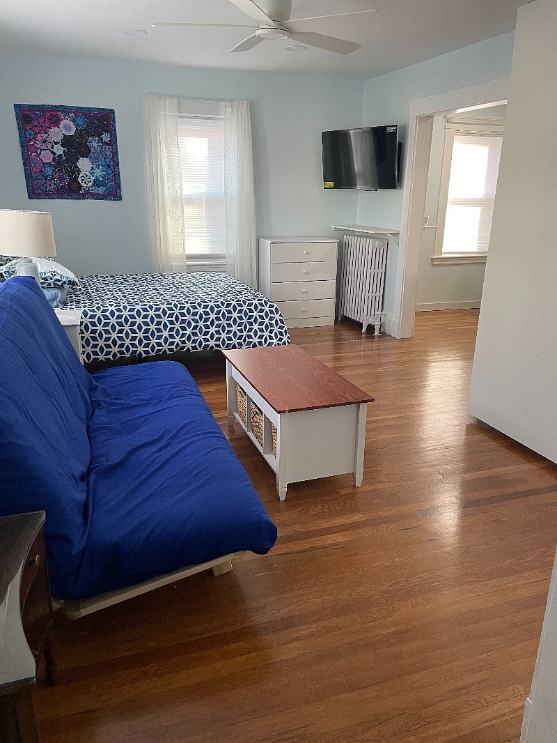 Living space with queen bed and queen futon.