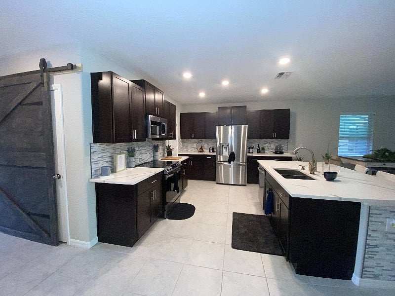 Open walk through luxurious  style concept kitchen with oversized bar island  

