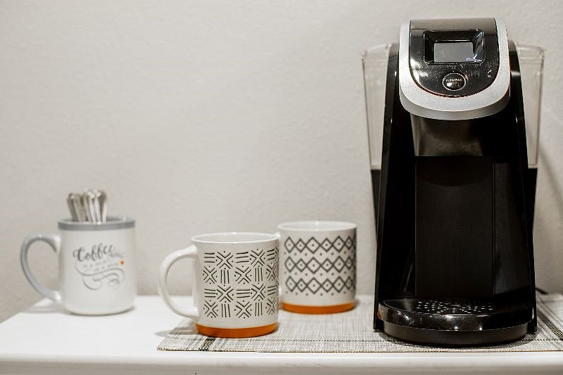 3 shelf coffee station has grinder, french press, Keurig and starter coffee