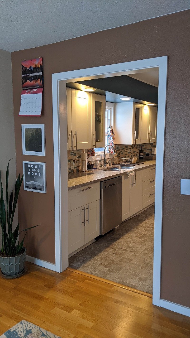 View from left side of the living room into the kitchen.