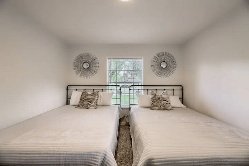 Two queen beds with luggage racks