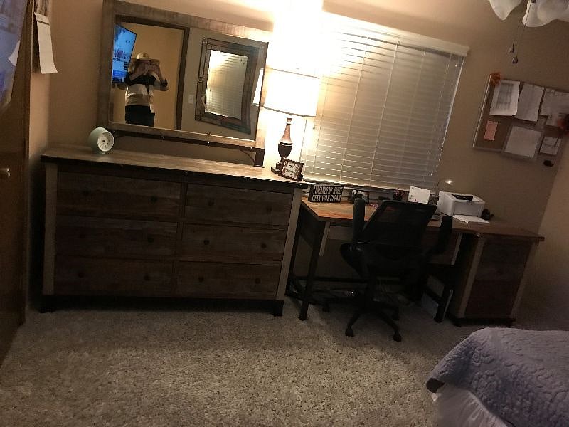 Bedroom with view of dresser & desk.