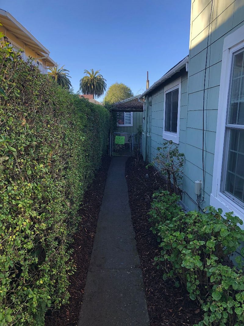 Private entrance and gated walkway to studio with keypad lockbox.