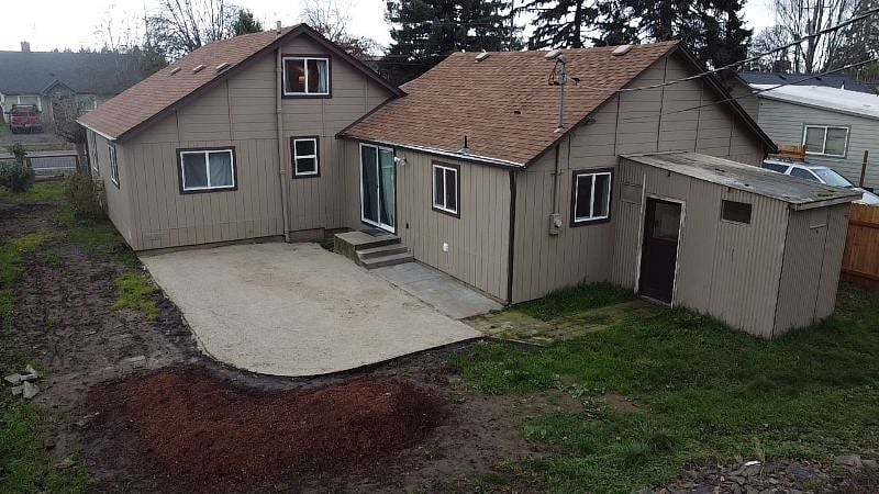 Backyard. Graveled area outside of back doors. Green area in remainder of backyard.