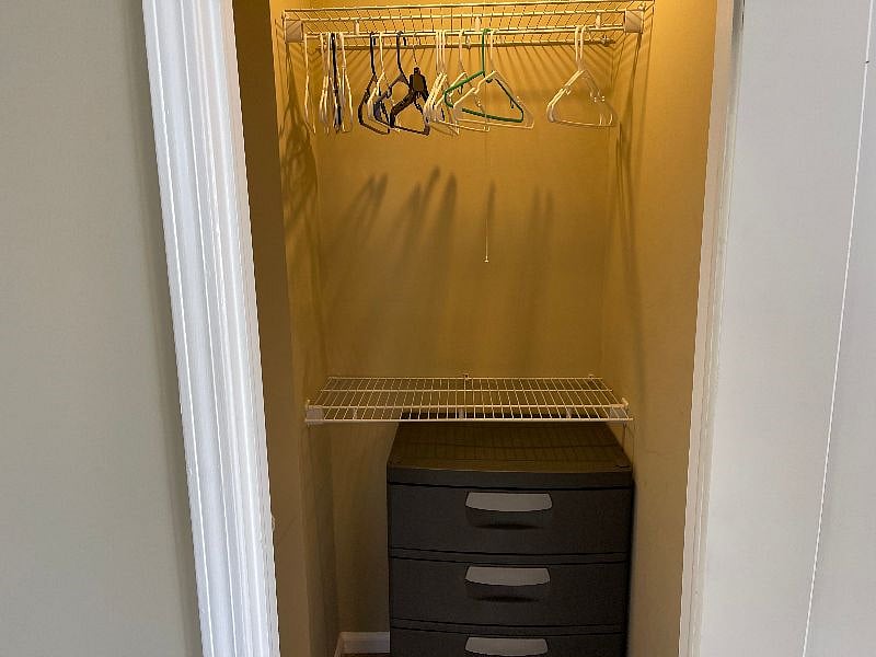 The master bedroom closet has plenty of hanging space and an additional portable dresser for extra storage.