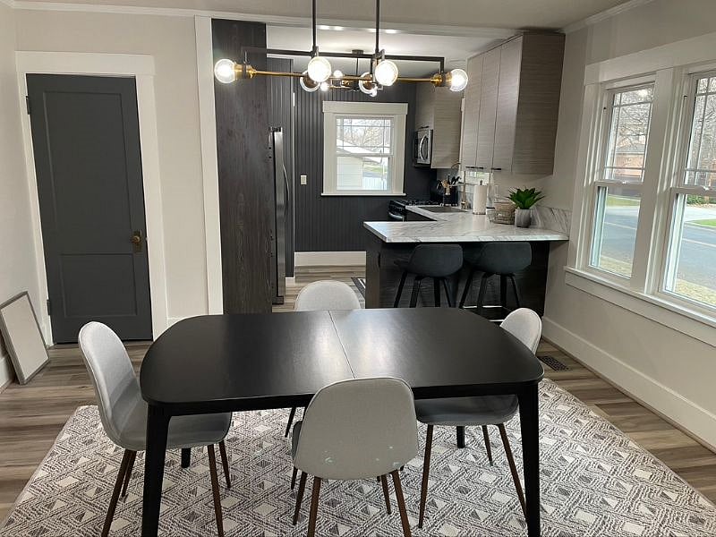 View of dining area into the open custom kitchen. Island is counter height and seats 2