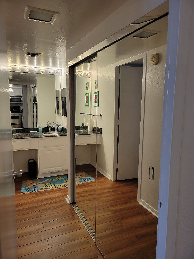 Plenty of closet space in the mirrors to the right and more in the bedroom