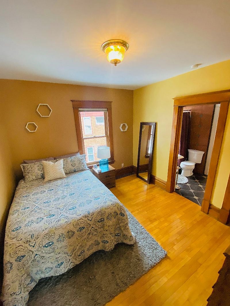 West bedroom with heated mattress pad, full-size bed, full-length mirror, and white noise machine