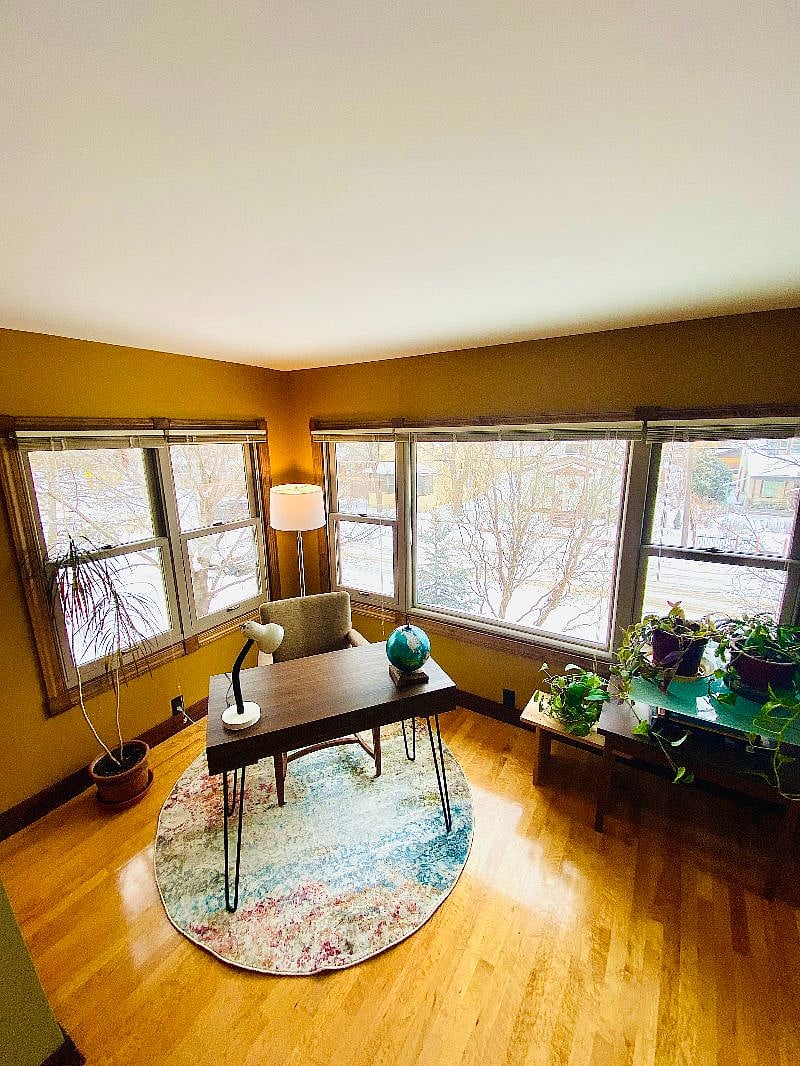 Peaceful workspace, surrounded by picture windows and urban treetops
