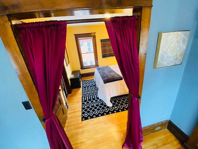 Enter the middle bedroom through the dining room curtains