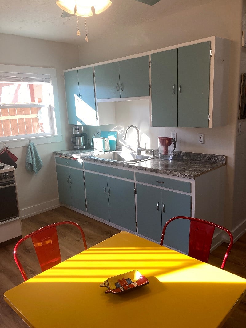 Restored 1950s kitchen is a classic with southerly light pouring in. I built a cat bed shelf in the window