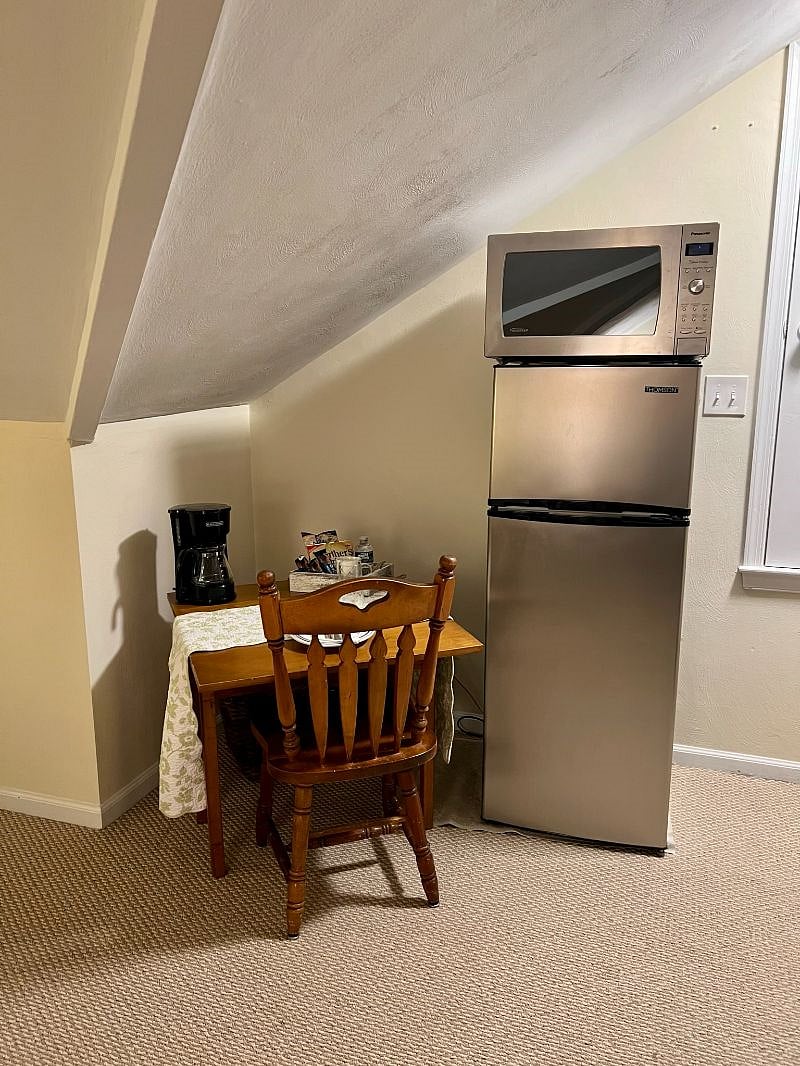 Dining table, 7 cubit ft refrigerator/freezer, and microwave.