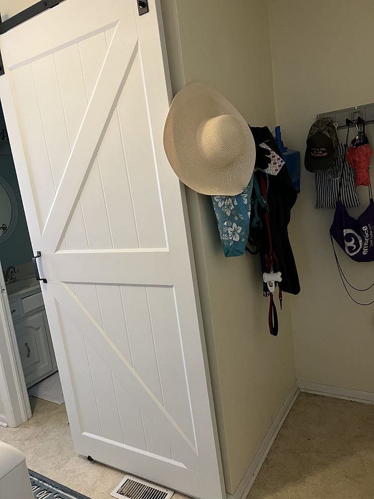 This is the view standing in the doorway from the kitchen to the laundry - door to the garage on the right, door to the screened porch on the left.