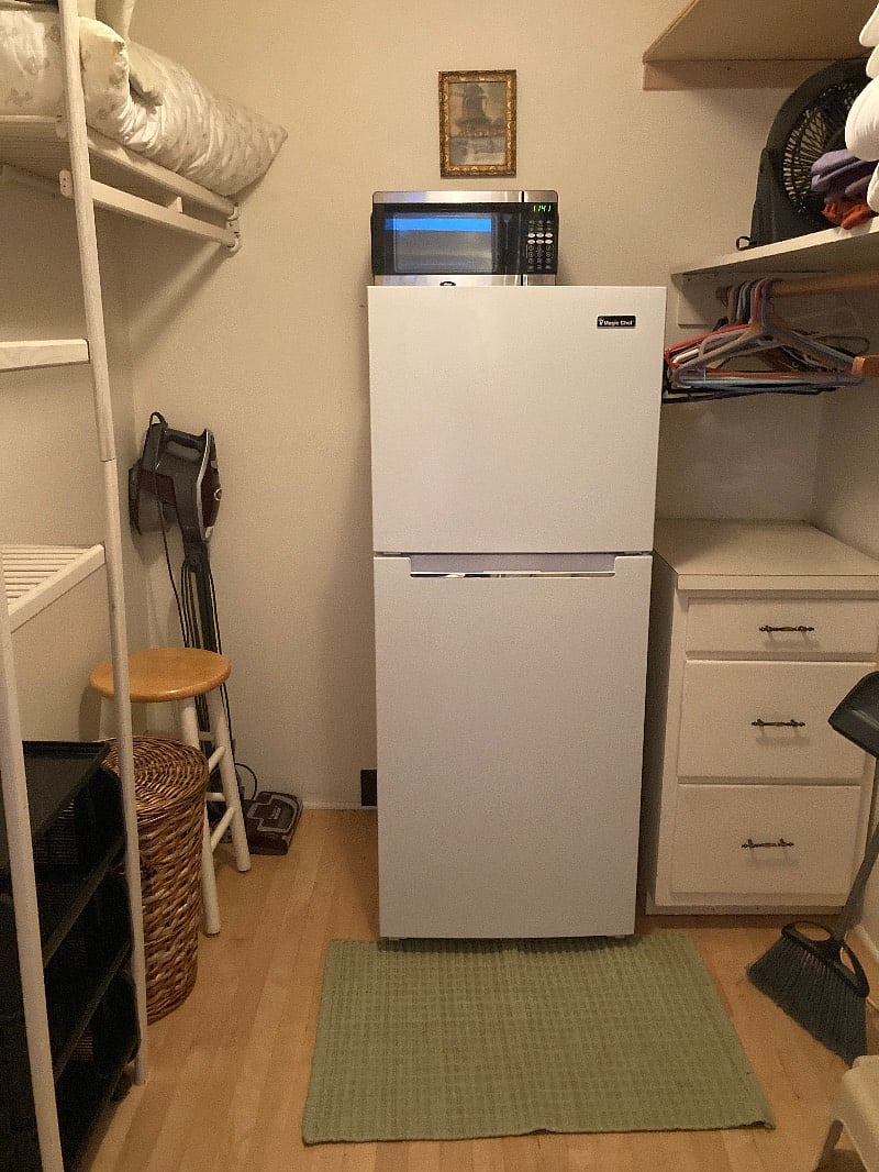 Full-sized new refrigerator conveniently placed inside closet out of the way