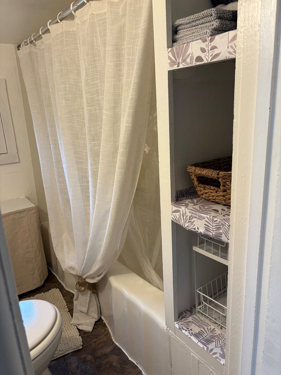 Average size person shower, the floor is raised and ceiling is low, anyone over 6' 1" would have to duck a bit.  
