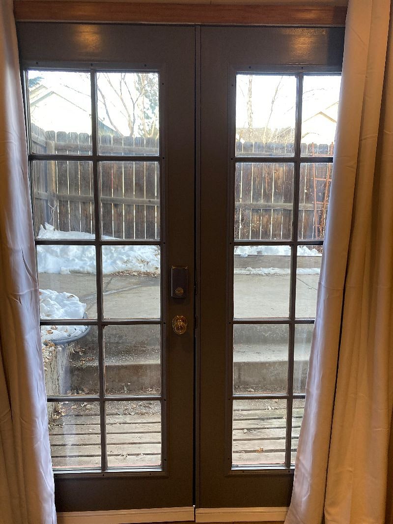 French doors, lovely to keep open in the summer! Open out to patio. Black-out curtains.