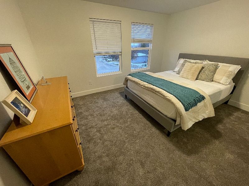 Bedroom 1 - Queen sized bed, brand new carpet and view of Simplot Hill flag