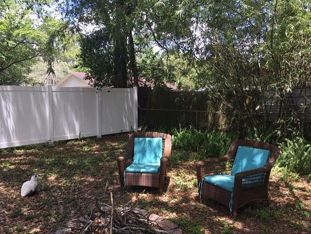 Shady backyard with seating area around fire pit