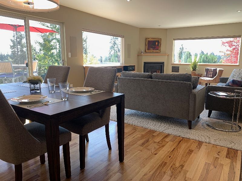 Living room with views to East and South, with fireplace in corner.