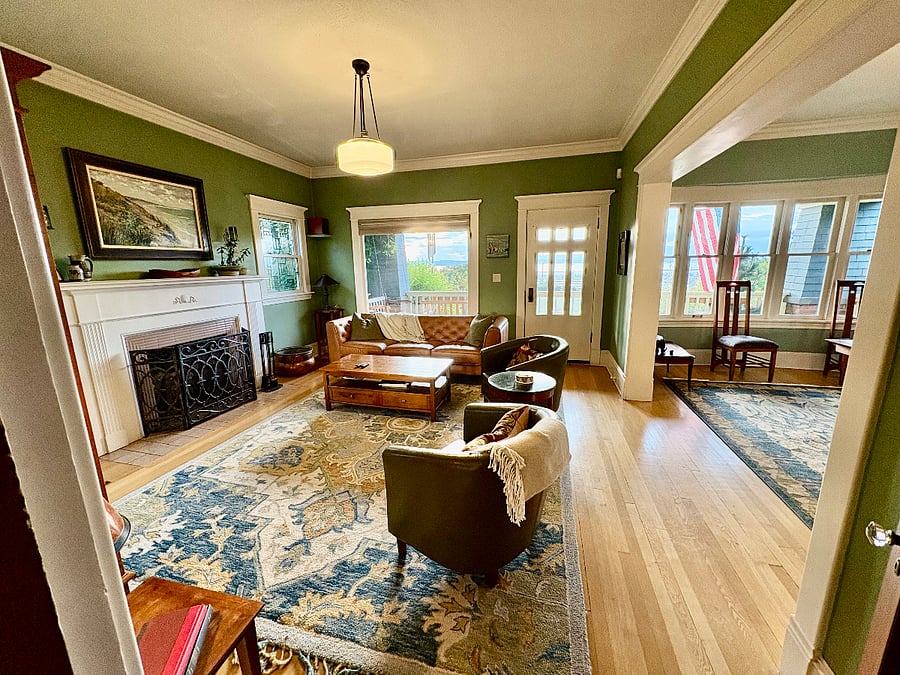 Living room facing west with full view of waterfront and park. North to south covered deck with swing and chairs.