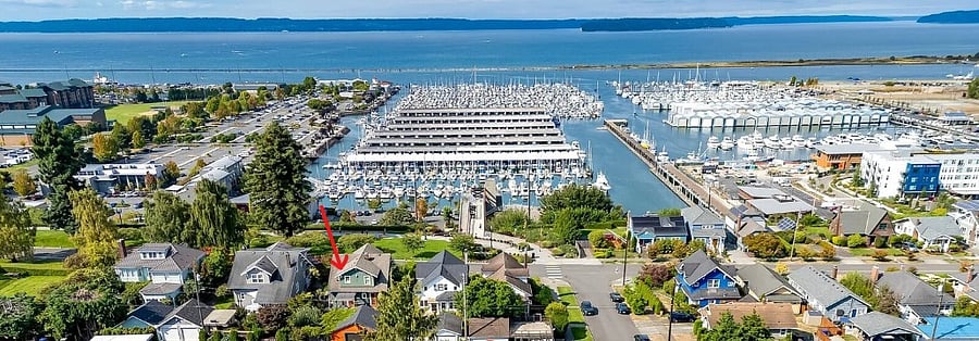 Aerial view. Red arrow as to where home sits above the waterfront. Access to waterfront with skybridge. Free concerts throughout the summer and other events. Winter has an ice rink and holiday events.