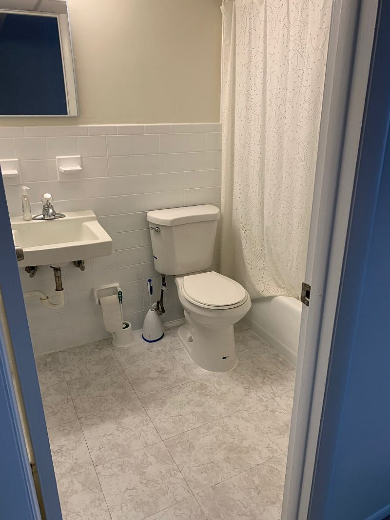 Clean full bathroom with tub.