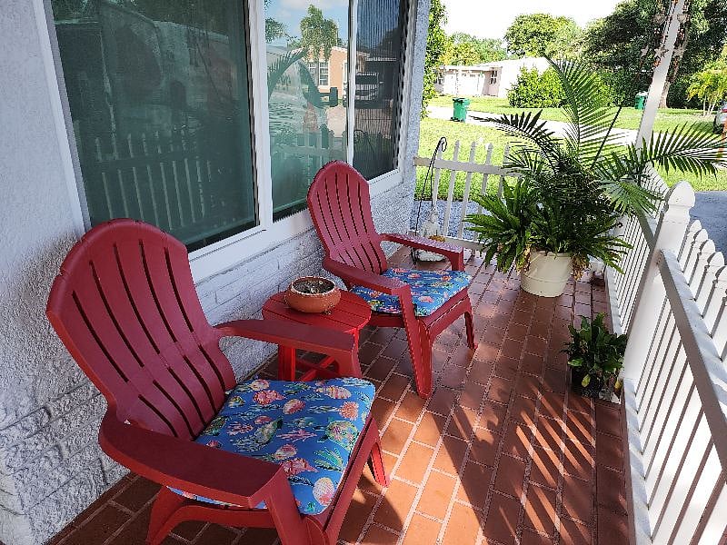 Additional seating in cozy and breezy front porch
