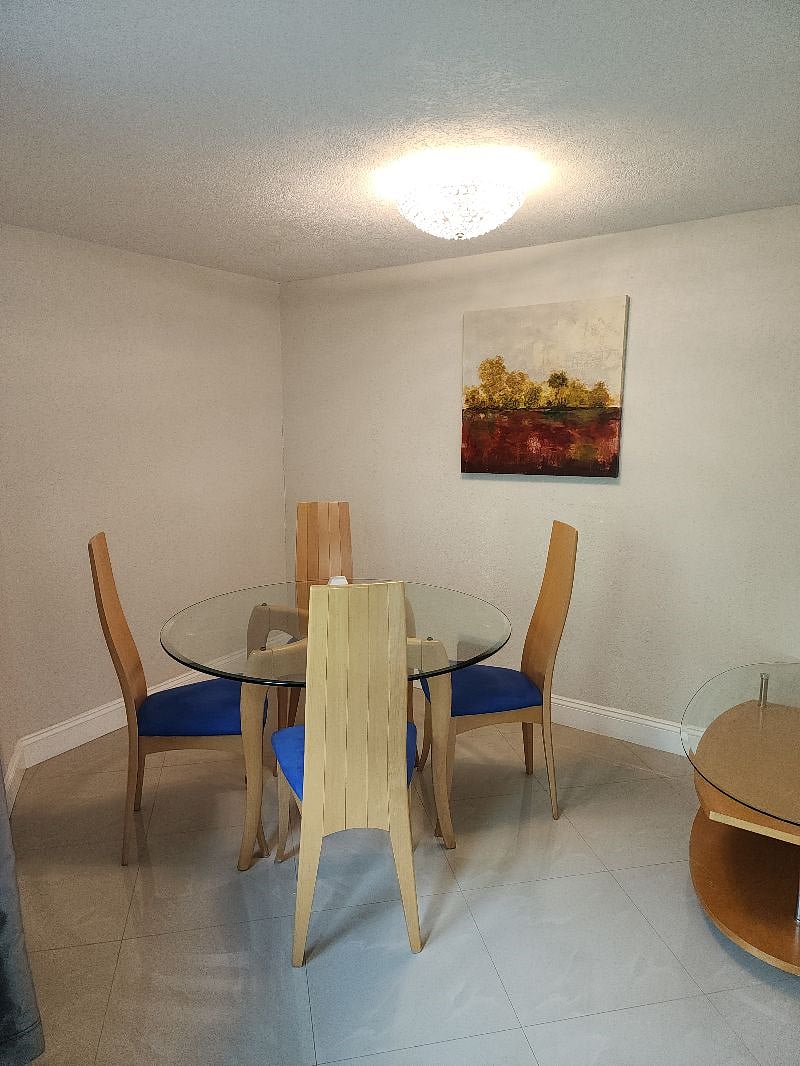 Dining room area - 4 chairs and glass table top & maneuverable serving glass table