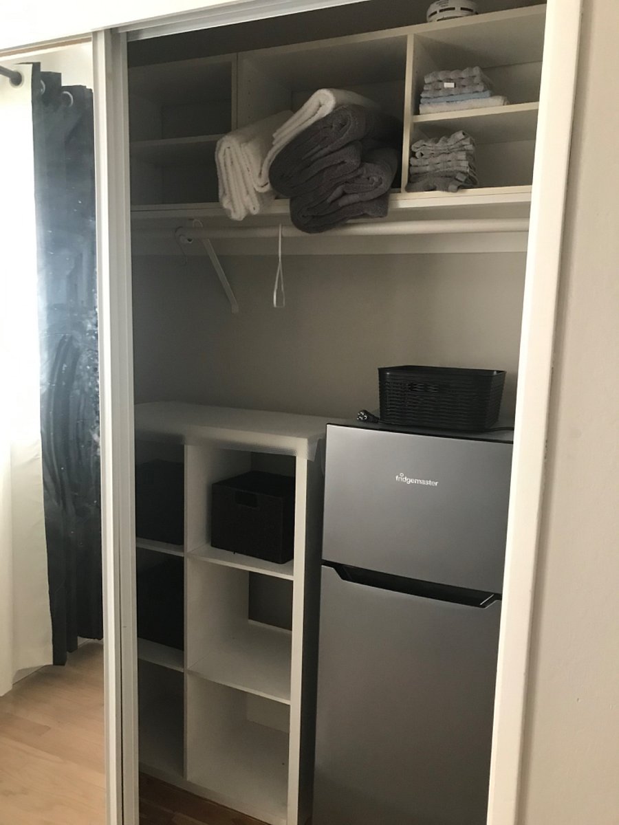 Room for rent counts with a smart tv, desk, and a small refrigerator.