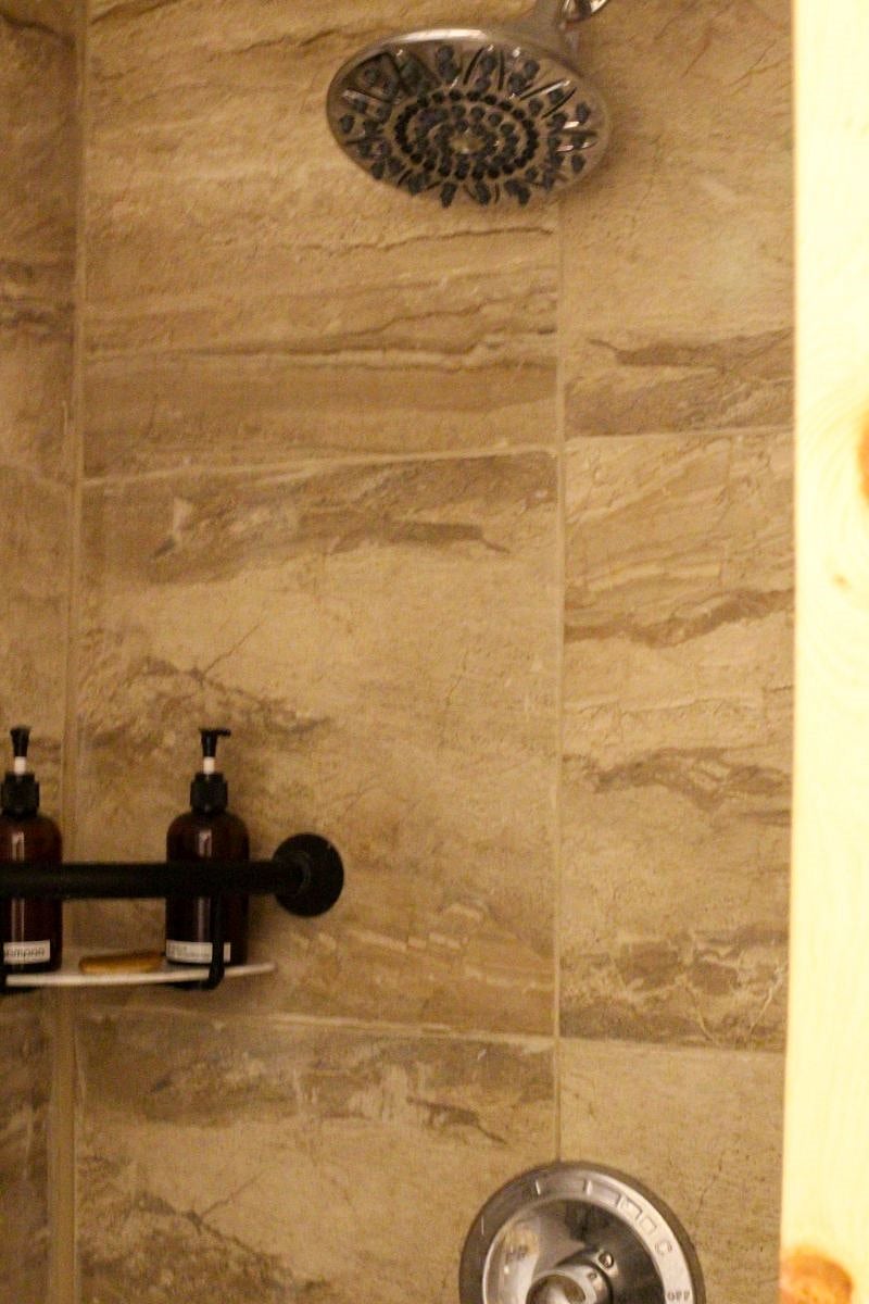 Tiled standing shower in ensuite bathroom