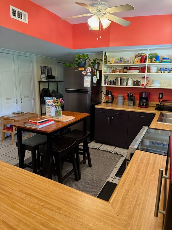 Island style table doubles as additional prep space as well as  dining setup for 4 people.
